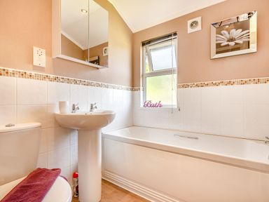 A bathroom with a bathtub a sink a toilet and a window at Lavender Lodge in Charlton Horethorne near Sherborne