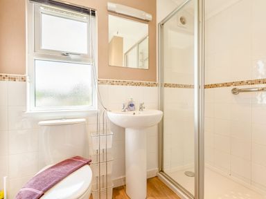 A bathroom with a toilet towel mirror sink and shower at Lavender Lodge in Charlton Horethorne near Sherborne