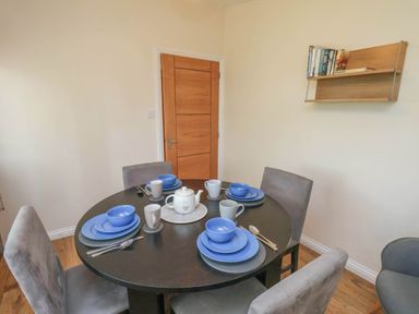 A dining room with a table set for tea at Primrose Lodge in Saltburn-by-the-Sea