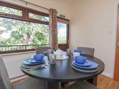A dining room with a table set for meals at Primrose Lodge Saltburn-by-the-Sea