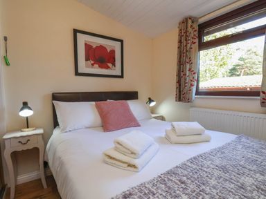 A bedroom with a double bed and bedside table at Primrose Lodge in Saltburn-by-the-Sea