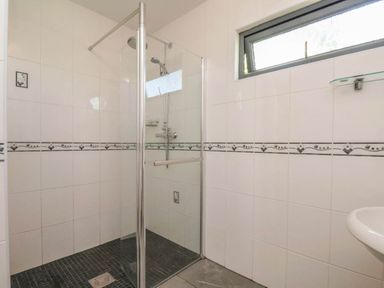 A bathroom with a shower and sink at Primrose Lodge in Saltburn-by-the-Sea