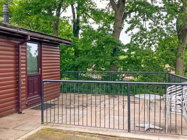 An outdoor patio with a table and chairs at Primrose Lodge Saltburn-by-the-Sea