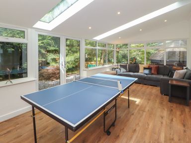 A snug with a ping pong table and a sofa at Eden House in Bardsea