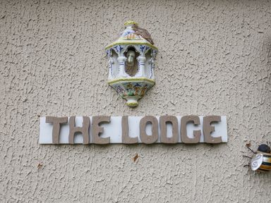 A sign that reads THE LODGE with a light fixture at The Lodge Old Buckenham near Attleborough