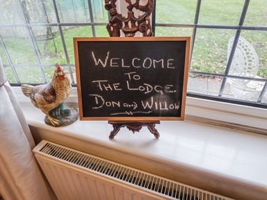 A welcome sign and chicken figurine at The Lodge in Old Buckenham near Attleborough