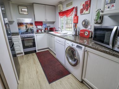 A kitchen with appliances and counter space at The Lodge in Old Buckenham near Attleborough