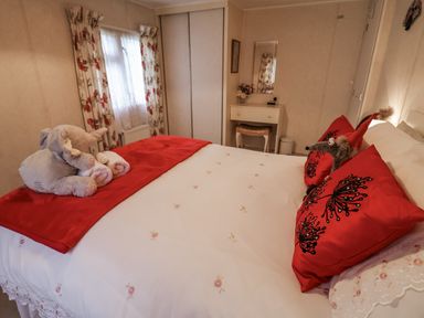 A bedroom with a bed and vanity table at The Lodge Old Buckenham near Attleborough