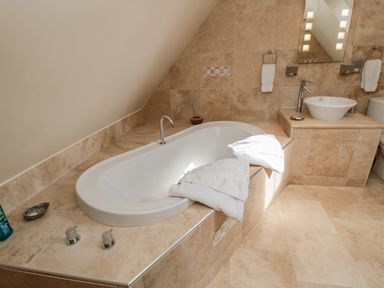 A bathroom with a bathtub sink and toilet at The Red Barn in Longframlington near Alnwick