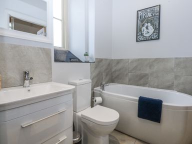A bathroom with a sink toilet and bathtub at Eglwys St Cynfil Penrhos near Pwllheli