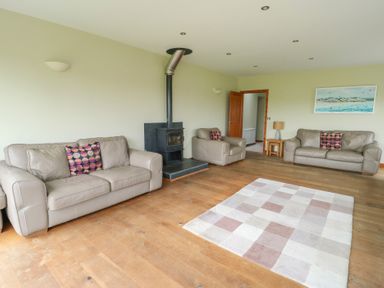 A living room with sofas and a fireplace at Chapel House Elim near Llanddeusant