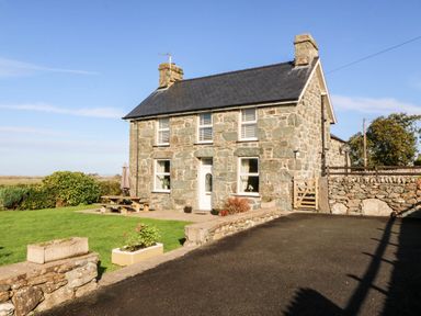A house with a stone exterior and garden at Tyddyn in Dyffryn Ardudwy