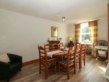 A dining room with a table and chairs at Tyddyn in Dyffryn Ardudwy