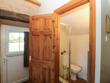A bathroom with a shower and toilet at Tyddyn in Dyffryn Ardudwy
