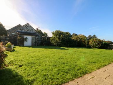 An outdoor area with a stone building and grass at Tyddyn in Dyffryn Ardudwy