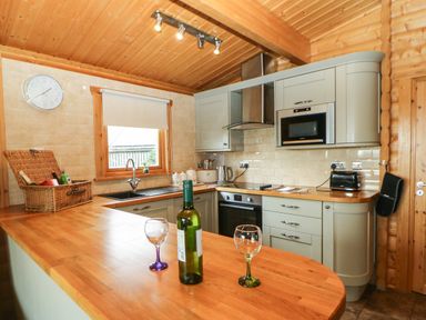A kitchen with wooden countertops cabinets and appliances including an oven microwave and toaster at Cornfield in Northallerton