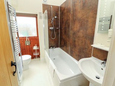A bathroom with a shower and bathtub at The Old Bothy Bolton Low Houses near Wigton