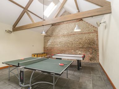 A games room with a ping pong table foosball table and air hockey table at Corner Barn in Winterborne Stickland