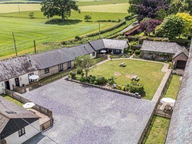 An outdoor area with buildings and garden at Corner Barn Winterborne Stickland