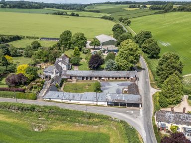 A farmhouse and surrounding fields at Corner Barn in Winterborne Stickland