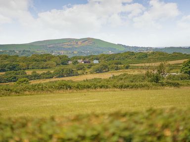 A rural landscape with fields trees and hills at The Dairy in Penuel near Llanmorlais