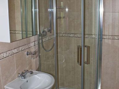 A bathroom with a sink and a glass-enclosed shower at Moat Farm Cottage in Wood Dalling