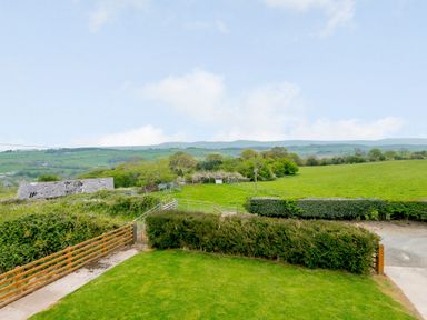 A rural landscape with green fields hedges and an old barn at Pen Y Gaer in Llannefydd near Abergele and Denbigh