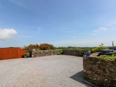 An outdoor area with a gravel surface and stone walls at The Stall in Penuel near Llanmorlais