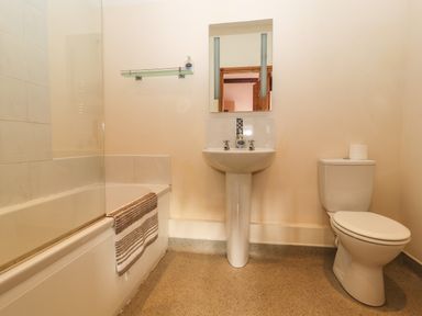 A bathroom with a bathtub a sink and a toilet at Maestyddyn Farm House in Clawddnewydd near Ruthin