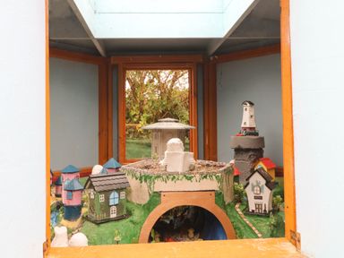 A display of miniature houses and buildings inside a wooden framed enclosure at Sutton Cottage Ballysheen near Rosslare Harbour County Wexford