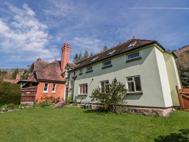A house with garden and trees at Gardener's Cottage Llanwrthwl near Rhayader