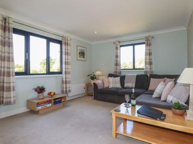A living room with a sofa and coffee table at The Station Flat St Newlyn East near Newquay
