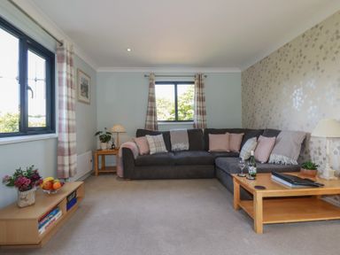A living room with a sofa and table at The Station Flat St Newlyn East near Newquay