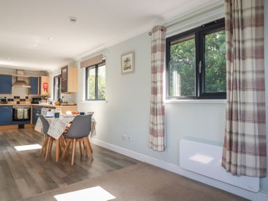 A kitchen with a table and chairs at The Station Flat St Newlyn East near Newquay