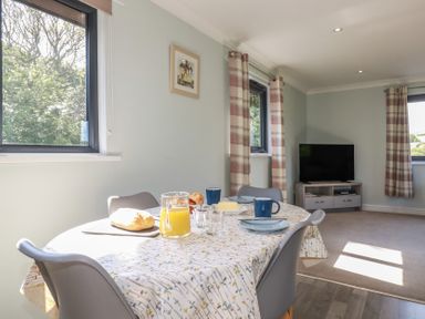 A dining room with a table set for breakfast at The Station Flat in St Newlyn East near Newquay