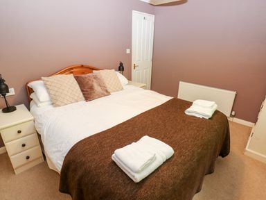 A bedroom with a double bed and bedside tables at The Beeches in Narberth