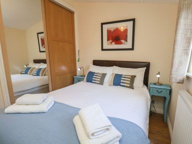 A bedroom with a bed and bedside table at Bluebell Lodge in Saltburn-by-the-Sea