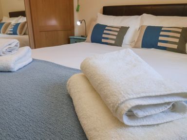 A bedroom with a bed and towels at Bluebell Lodge Saltburn-by-the-Sea