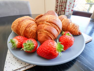 A plate with croissants and strawberries