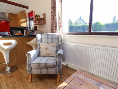 A kitchen with a chair and table at Violet Lodge in Saltburn-by-the-Sea