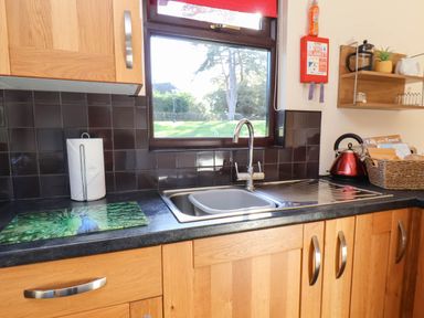A kitchen with a sink and cabinets at Violet Lodge in Saltburn-by-the-Sea