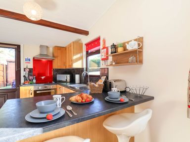 A kitchen with a table set for breakfast with snacks at Violet Lodge in Saltburn-by-the-Sea