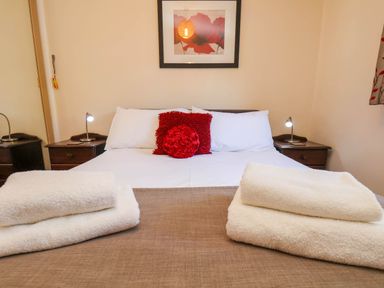 A bedroom with a double bed and nightstands at Violet Lodge in Saltburn-by-the-Sea