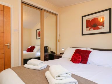 A bedroom with a bed and towels at Violet Lodge Saltburn-by-the-Sea