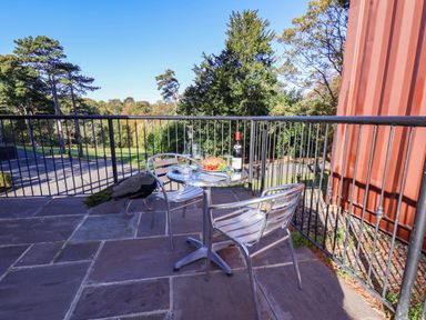 An outdoor area with a table and chairs at Violet Lodge in Saltburn-by-the-Sea