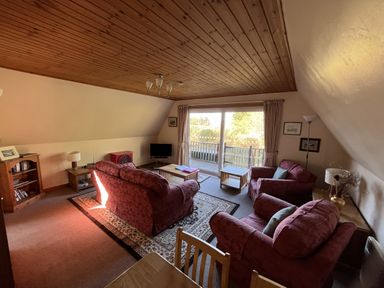 A living room with sofas and a coffee table at Suil Na Mara in Aultbea