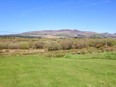 A landscape view of mountains and fields at Stone Cottage in Waterville, County Kerry