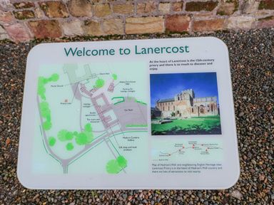 A welcome sign with a map and image of Lanercost Priory at Hadrians Wall Banks near Brampton