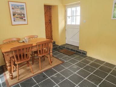A dining room with a table and chairs at Swallows, St Keverne, Lizard Peninsula