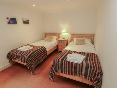 A bedroom with two beds and a nightstand at Winster Fields Cartmel Fell near Windermere